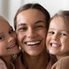 Happy Woman Smiling with Two Children